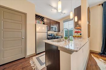 a kitchen with a large island and stainless steel appliances  at Avellan Springs Apartments, Morrisville, NC, 27560